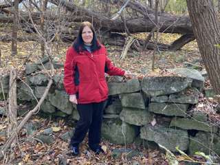 Beth Livingston with what is left of the stone wall