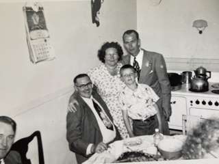 Violet, husband, and kids in her kitchen